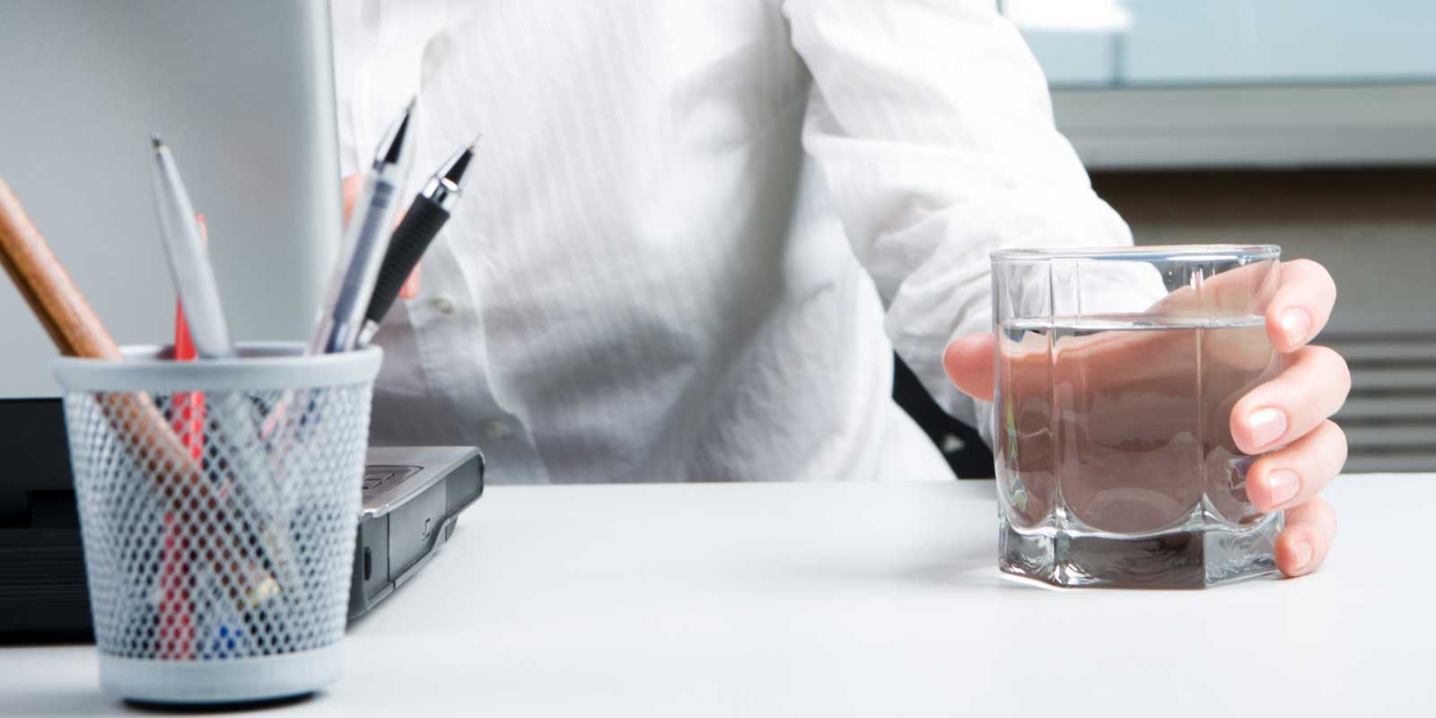 CEO drinking a glass of still water