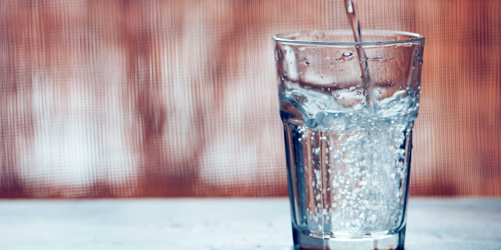 Sparking water being poured into a glass