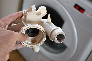 Hard water limescale build-up in washing machine pipe