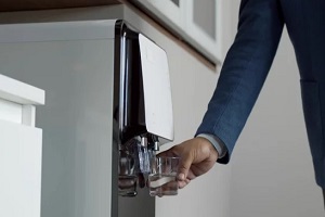 man taking water from medorn water cooler