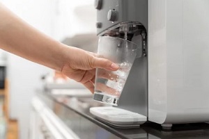 taking water in glass from cooler