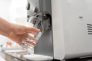 filling water glass from bottleless water cooler
